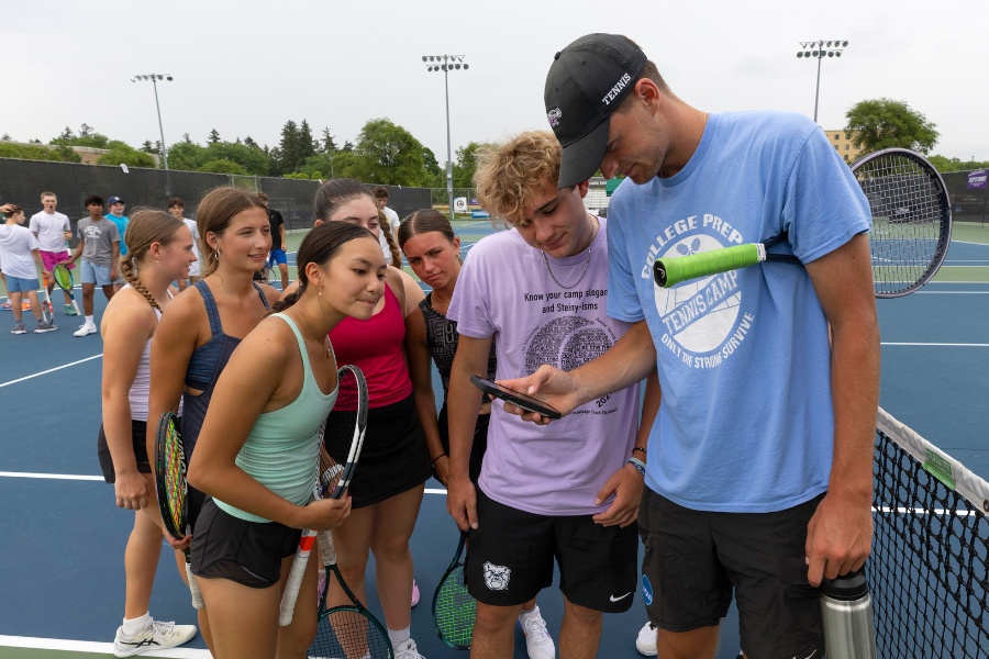 Photo of campers looking into a phone.