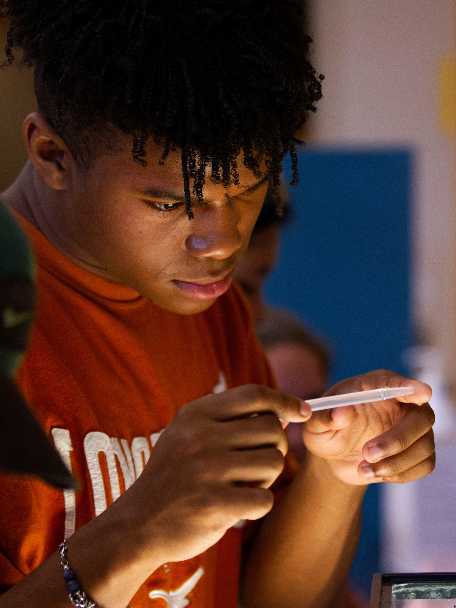 Camper Adam Turner collects pinpoint-sized water fleas for a toxicity experiment in a lab on June 16, 2022, during a weeklong Freshwater Camp jointly presented by UW-Whitewater and UW-Parkside and led by Professor Elisabeth Harrahy.