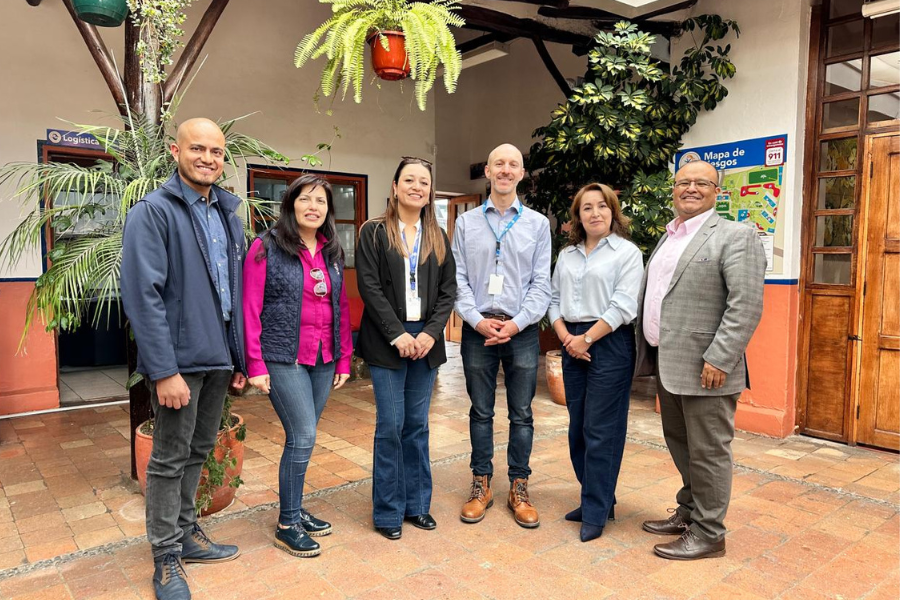 A group of six people stand together and pose for a photo.