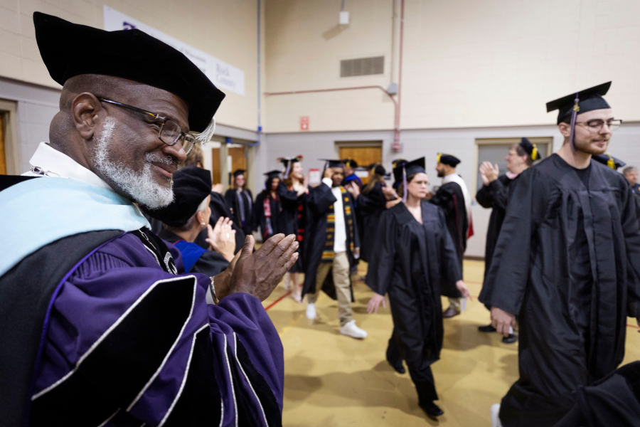 Chancellor Corey A. King joins faculty in welcoming graduates as they process into the gym. The College of Integrated Studies on the UW-Whitewater at Rock County campus held its commencement ceremony on Tuesday, May 20, 2025, in Frank Holt Gymnasium at Wells Cultural Center.