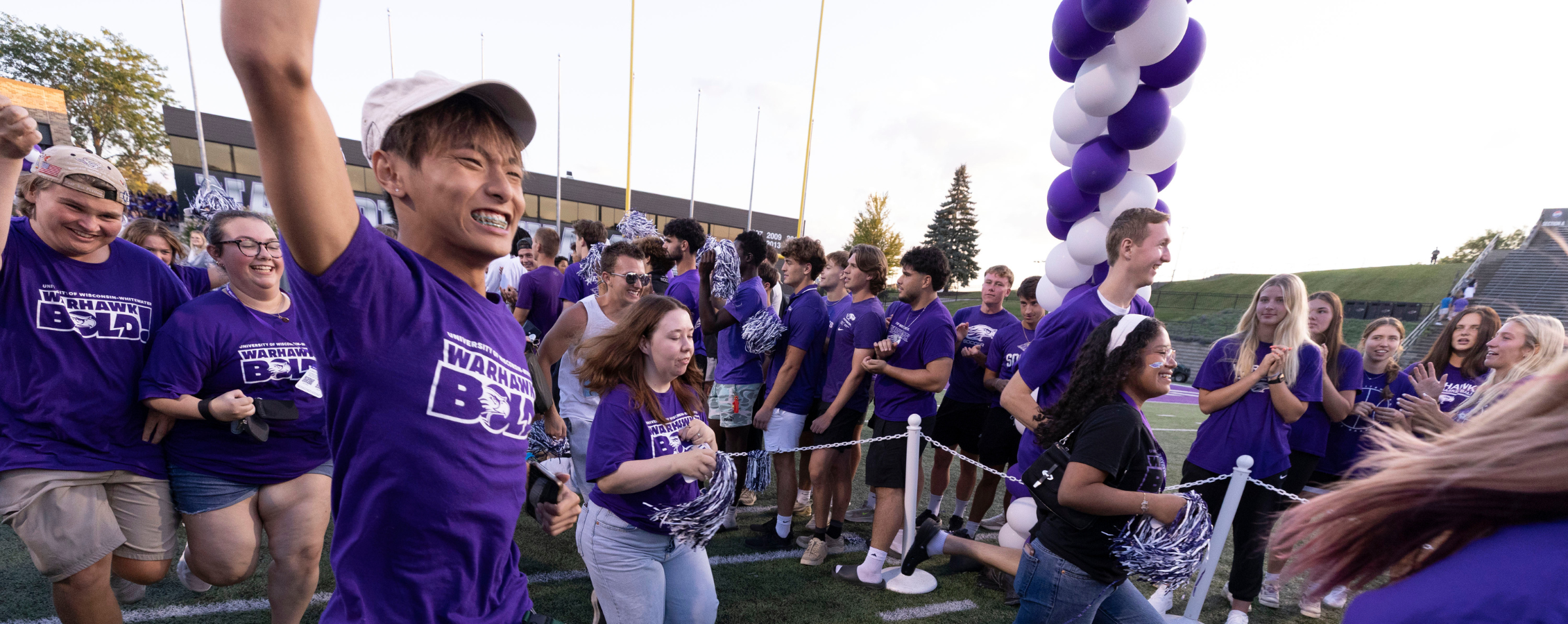 Students running through tunnel during the R U Purple tradition.