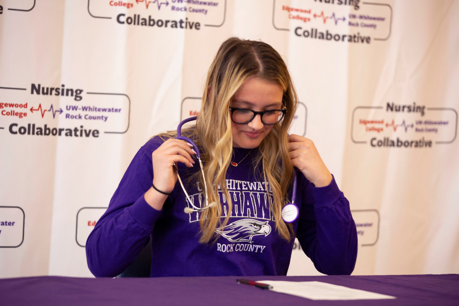 A bolt of lighting crosses the sky behind Hyer Hall and the sky looks purple.