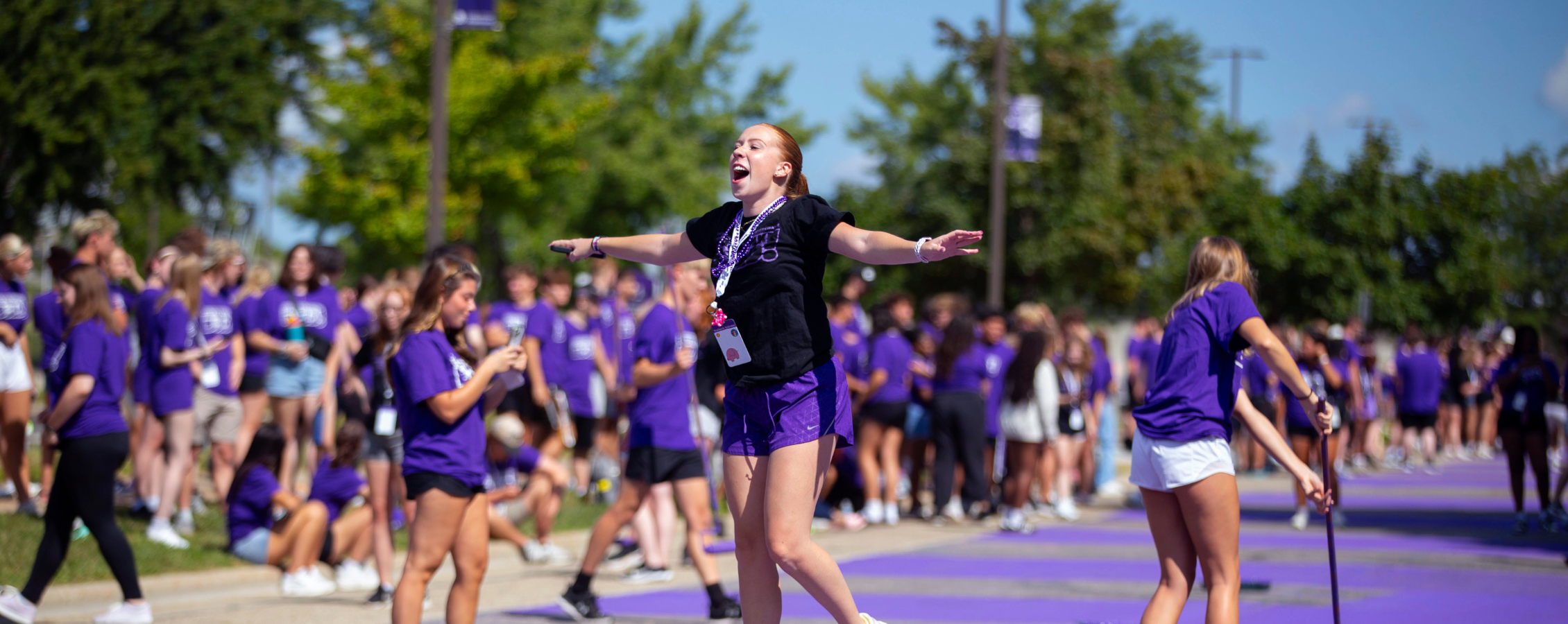 Student jumps of excitement during Paint It Purple tradition.