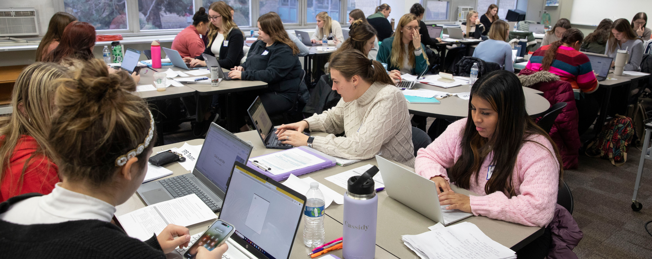 Students do work on computer.