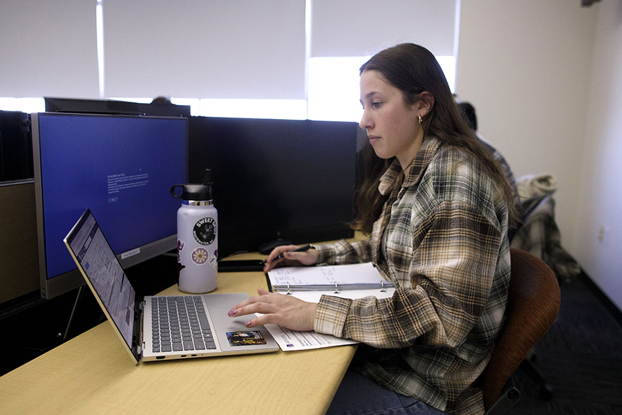 A student works on their laptop.