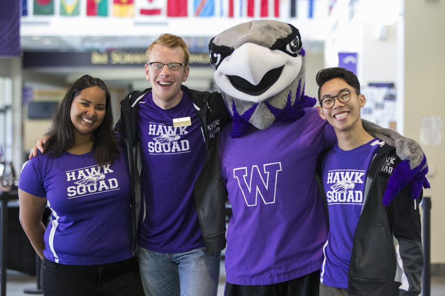 Willie stands with three Hawk Squad members in the University Center.