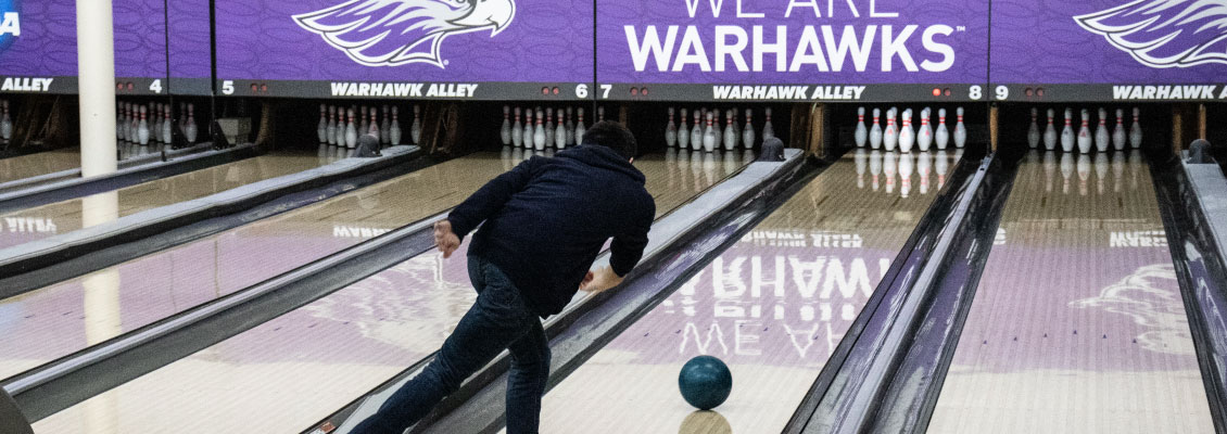 Student bowling in Warhawk Alley